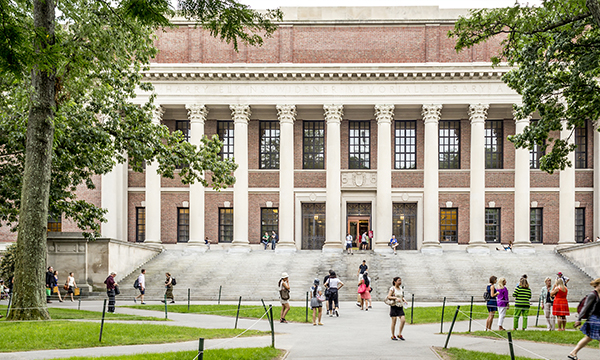A siloed image of a campus building with students walking