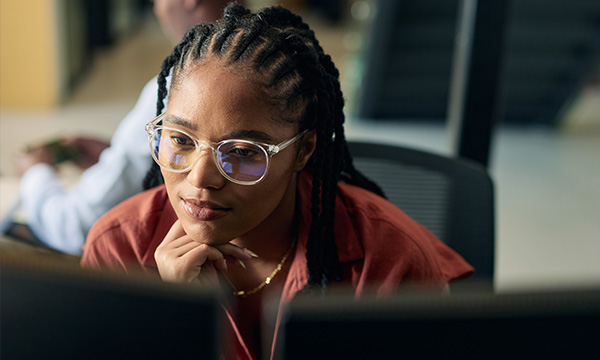 A hero banner image of a woman looking at a computer screen