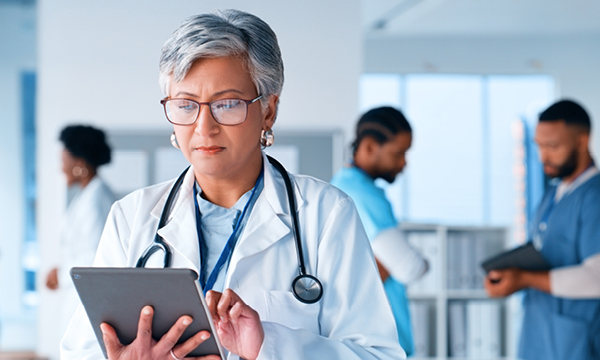 Healthcare market research banner; a healthcare professional in a white coat looking at a chart